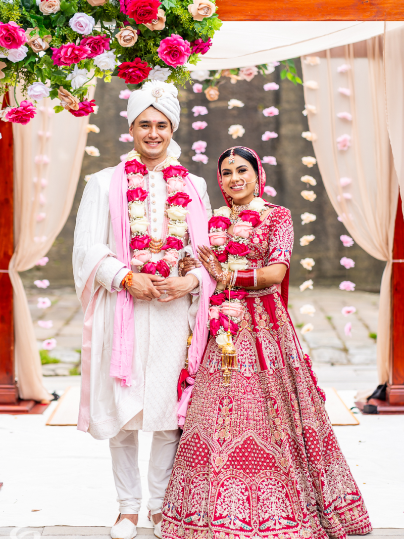 Shubhra and Morgan wearing flower garlands after their Hindu wedding ceremony at Gunners Barracks, Mosman