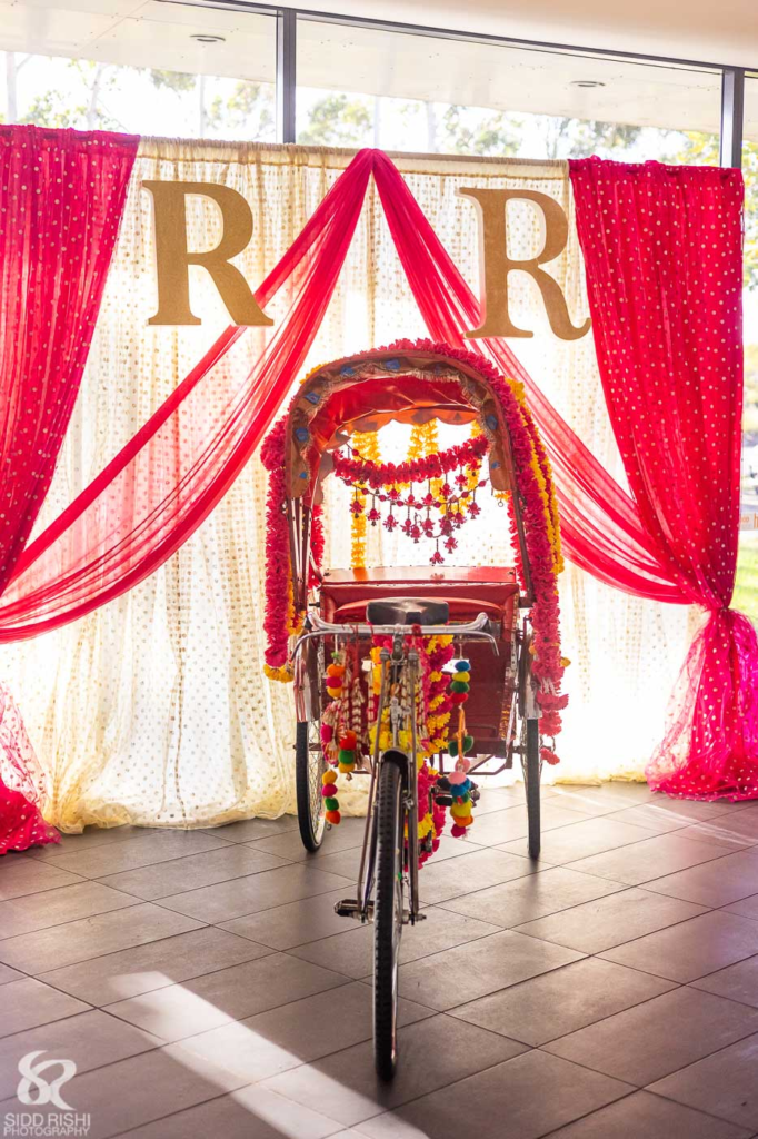Decorated rickshaw and floral backdrop at a sangeet in Glenwood, Sydney