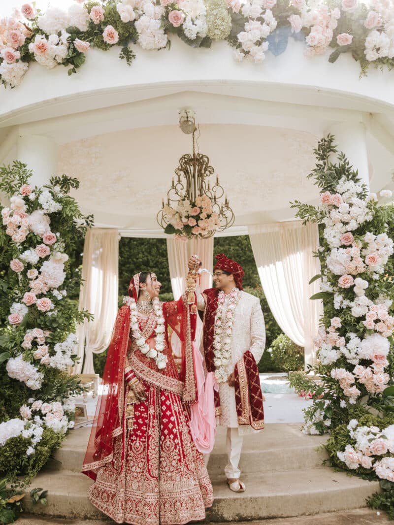 Annika and Abhishek under the mandap at their Hindu wedding ceremony at Miramare Gardens, Sydney